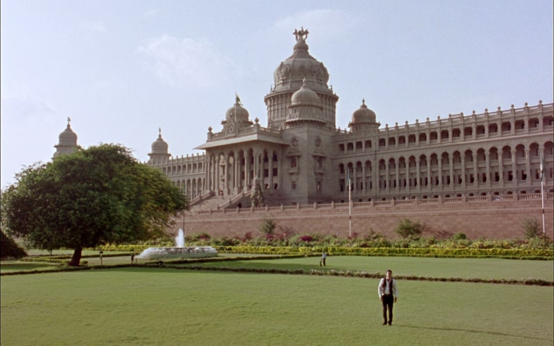 The Vidhana Soudha in Bengaluru seen across its lawns on a clear day.