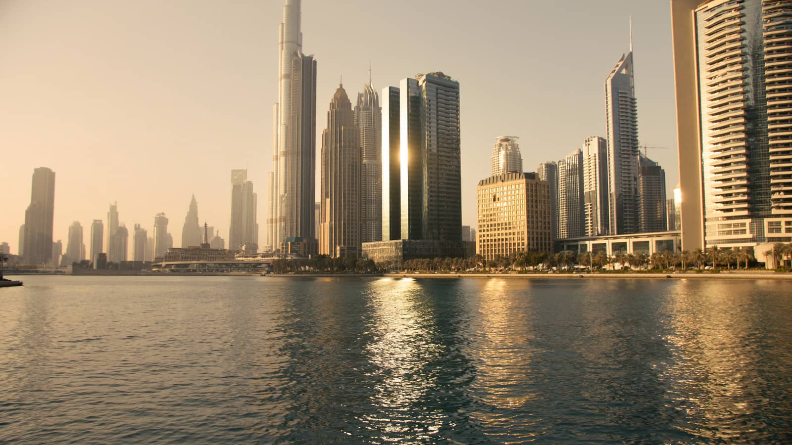 Dubai's downtown skyline seen from the water, high-rise towers along the waterfront.