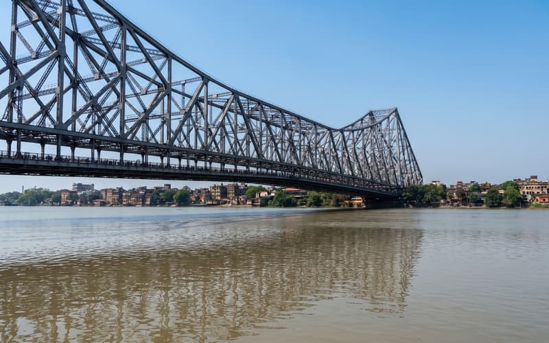 Howrah Bridge spanning the Hooghly in Kolkata, its steel truss above the river traffic.