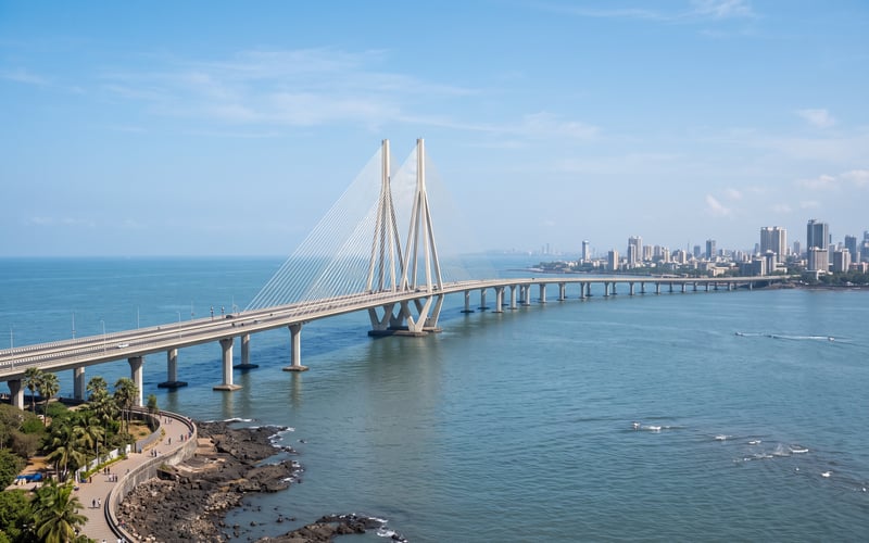 The Bandra–Worli Sea Link bridge in Mumbai arcing over calm water, the city skyline behind it in daylight.