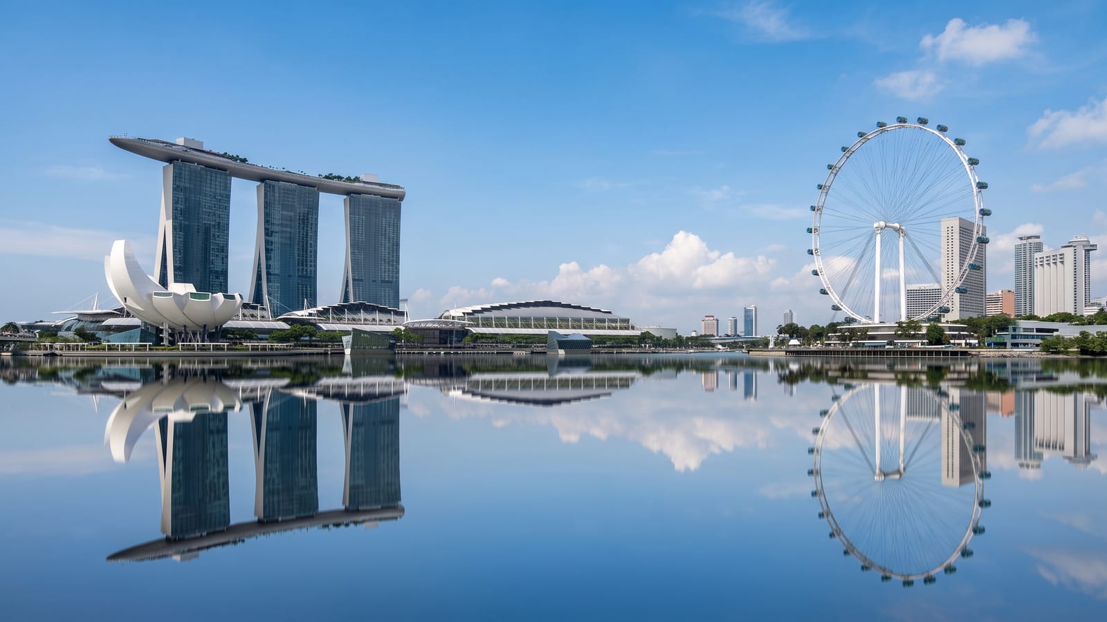 The Marina Bay skyline in Singapore in daylight, towers and the waterfront seen across the bay.